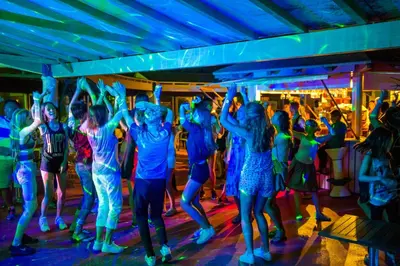 a group of people dancing at a party on a cruise ship at Goélia Le Village Club Marin in Port-la-Nouvelle