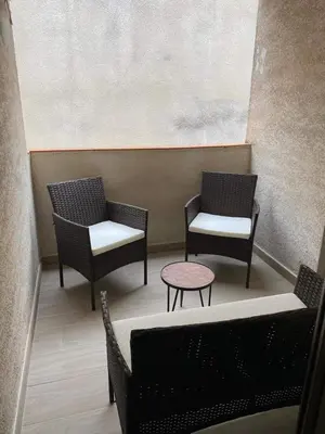 two chairs and a table in a waiting room at Bella Noche by D&O in Carcassonne