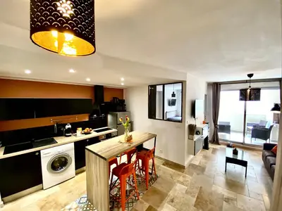 a kitchen and living room with a table and chairs at Bella Noche by D&O in Carcassonne