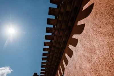 a building with the sun in the sky at Le Couvent - Hostel in Carcassonne