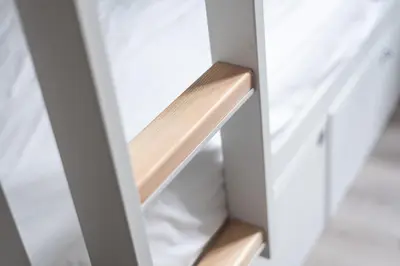a closet door with a wooden shelf in it at Le Couvent - Hostel in Carcassonne