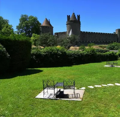 a playground in the grass in front of a castle at GOOD KNIGHT in Carcassonne