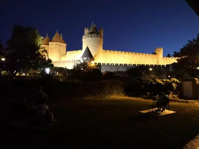 a large castle is lit up at night at GOOD KNIGHT in Carcassonne