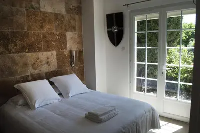 a bedroom with a bed with two towels on it at GOOD KNIGHT in Carcassonne