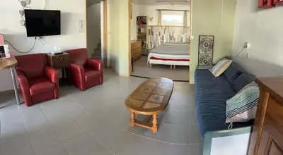a living room with a couch and a table at GITE Florence et Francis in Cuxac-dʼAude