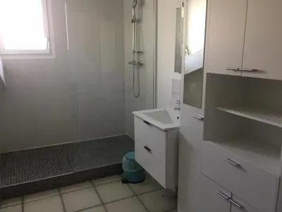 a white bathroom with a sink and a shower at B & B Florence et Francis in Cuxac-dʼAude
