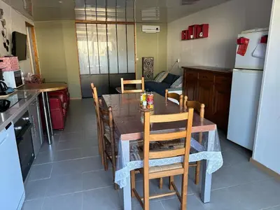 a kitchen with a table and chairs in a kitchen at B & B Florence et Francis in Cuxac-dʼAude