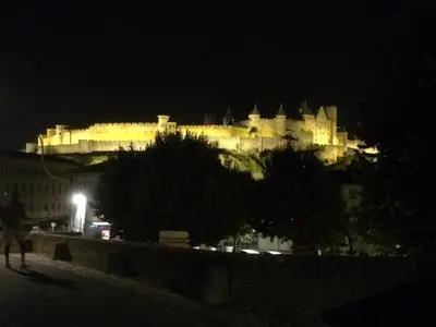 a large castle is lit up at night at Studio l'Obrador 25 m2 - Cuisine & terrasse - accès piscine in Rieux-Minervois