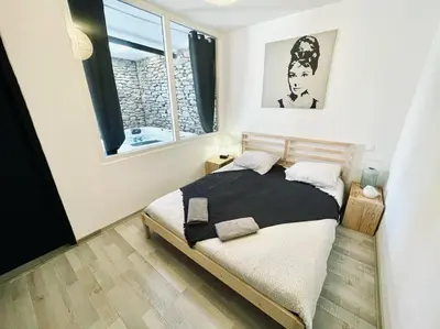 a bedroom with a bed and a window at Le cocon de Lenny in Conques-sur-Orbiel