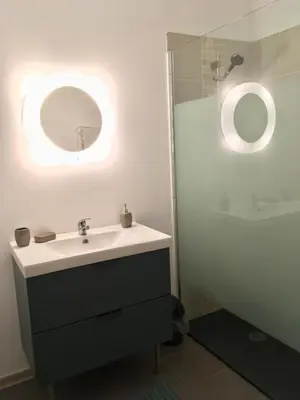 a bathroom with a sink and a mirror at Le cocon de Lenny in Conques-sur-Orbiel