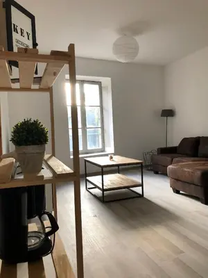 a living room with a couch and a coffee table at Le cocon de Lenny in Conques-sur-Orbiel