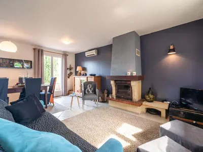 a living room with a couch and a fireplace at Villa in Caunes-Minervois with Private Pool in Caunes-Minervois