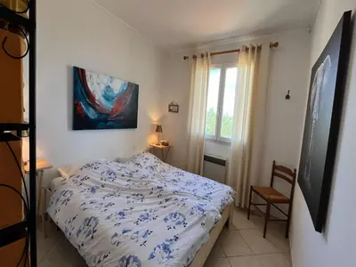 a bedroom with a bed and a painting on the wall at Villa in Caunes-Minervois with Private Pool in Caunes-Minervois
