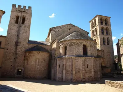 an old building with a tower and a church at Villa in Caunes-Minervois with Private Pool in Caunes-Minervois