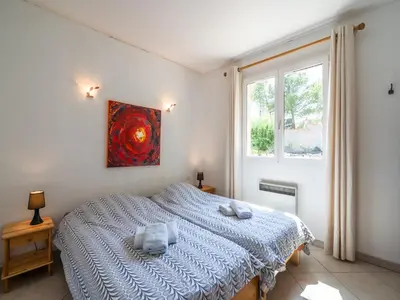 a bedroom with a bed and a painting on the wall at Villa in Caunes-Minervois with Private Pool in Caunes-Minervois