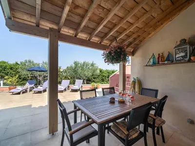a wooden table and chairs on a patio at Villa in Caunes-Minervois with Private Pool in Caunes-Minervois