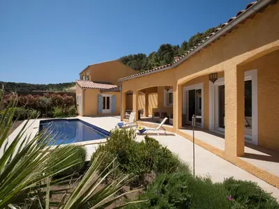a house with a swimming pool in a yard at Roquebrun Villa with Pool in Roquebrun