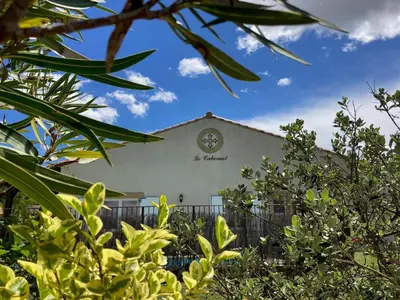 a building with a clock on the side of it at Comfortable villa with jacuzzi in Montbrun-des-Corbières