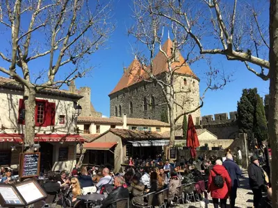 a crowd of people standing in front of a castle at Comfortable villa with jacuzzi in Montbrun-des-Corbières
