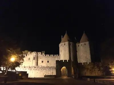 a large white castle at night at Comfortable villa with jacuzzi in Montbrun-des-Corbières