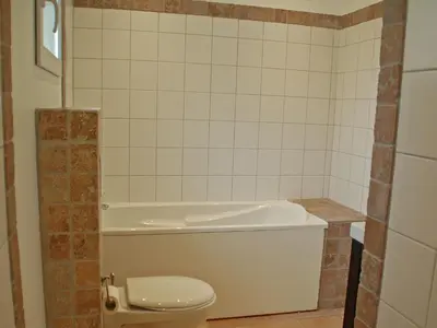a bathroom with a toilet and a bath tub at Comfortable villa with jacuzzi in Montbrun-des-Corbières