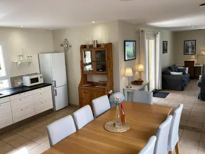 a kitchen and a dining room with a table and chairs at Cosy villa with pool in Montbrun-des-Corbières