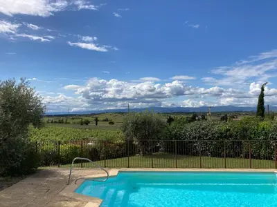 a swimming pool in front of a fence at Cosy villa with pool in Montbrun-des-Corbières
