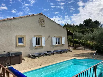 a house with a swimming pool next to a building at Cosy villa with pool in Montbrun-des-Corbières