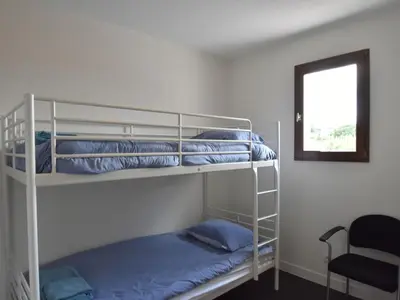 two bunk beds in a room with a window at Luxe Villa in Montbrun in Montbrun-des-Corbières