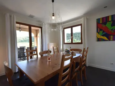 a dining room with a wooden table and chairs at Luxe Villa in Montbrun in Montbrun-des-Corbières