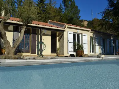 a house with a swimming pool in front of it at Tranquil Vineyard Villa, Berlou in Berlou