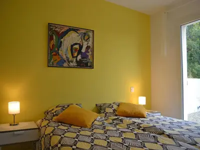 a bedroom with a bed and a painting on the wall at Tranquil Vineyard Villa, Berlou in Berlou