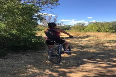 a woman riding a bike on a dirt trail at Tranquil Vineyard Villa, Berlou in Berlou