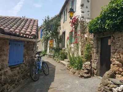 a bike parked on a street in an alley at Tranquil Vineyard Villa, Berlou in Berlou
