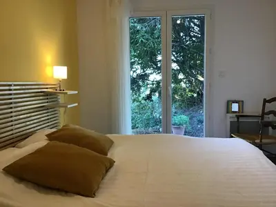 a bedroom with a large white bed with a window at Tranquil Vineyard Villa, Berlou in Berlou