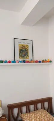 a shelf with a picture on top of it at Le Nid de Jeanne in Lézignan-Corbières
