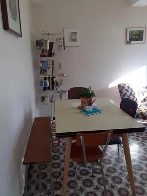 a dining room with a table and two chairs at Le Nid de Jeanne in Lézignan-Corbières