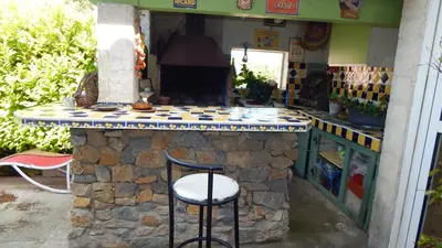 a stone counter with a stool in front of it at La Maison de Fafa in Carcassonne