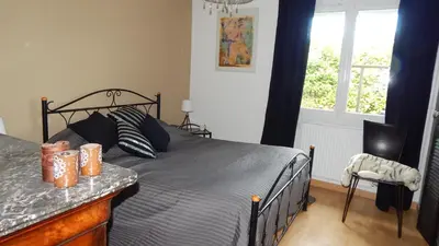 a bedroom with a bed and a window at La Maison de Fafa in Carcassonne
