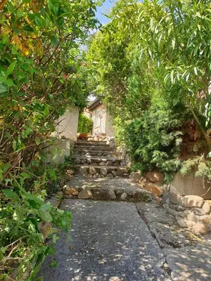 a stone path leading to a house with trees at La Maison de Fafa in Carcassonne