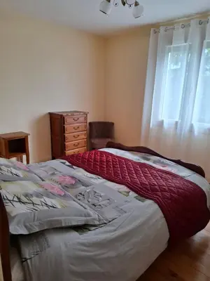 a bedroom with a bed and a dresser and a window at La Colombe in Revel