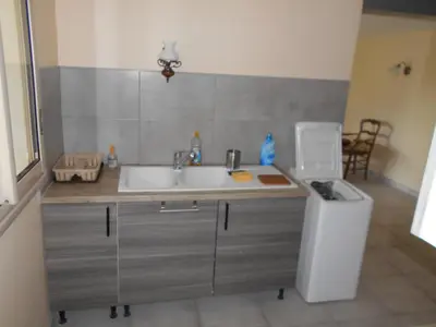 a kitchen with a sink and a trash can at La Colombe in Revel