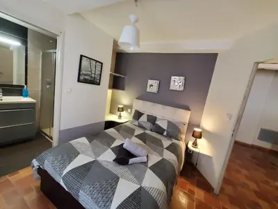 a bedroom with a black and white bed with two lamps at REPUBLIQUE Centre in Carcassonne