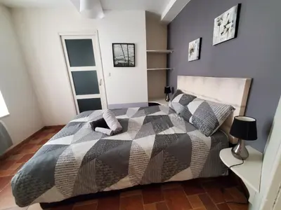 a bedroom with a bed with a black and white comforter at REPUBLIQUE Centre in Carcassonne