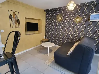 a living room with a couch and a table at REPUBLIQUE Centre in Carcassonne