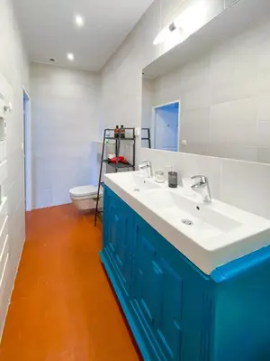 a bathroom with a blue and white sink and a toilet at Entre Midi - Maison d'Hôtes - B&B in Capestang