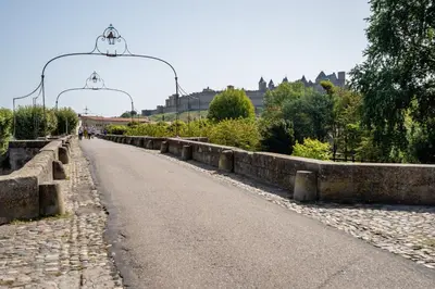 a bridge with two lights over a road at La suite numéro 1 in Carcassonne