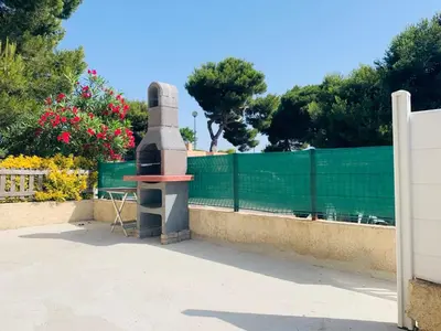 a statue sitting next to a fence at La Pinède in Gruissan
