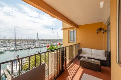 a balcony with a view of a marina at Appartement et Studio Le Méditerranée Port Soleil in Gruissan