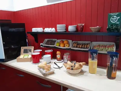 a counter in a restaurant with food and drinks at Fasthotel Narbonne in Narbonne